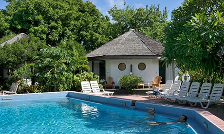 Swimming pool and hut at Kariwak Village in Tobago.