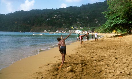 Tobago boys playing cricket on the beach.