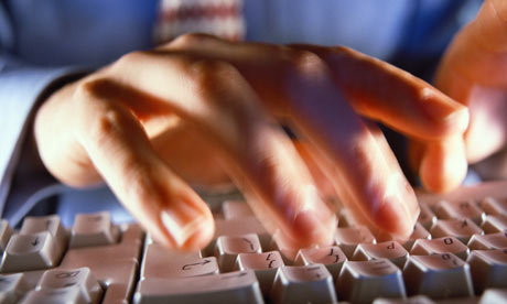 Man typing on a computer keyboard