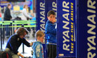 People queue at the Ryanair check-in desk at Dublin International airport