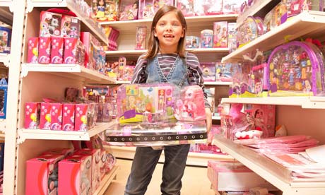 Little girl with pink toys Girls are targeted from an early age by the 