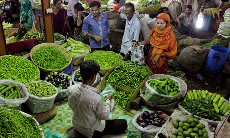 Indians shop for vegetables at a market in Ahmedabad