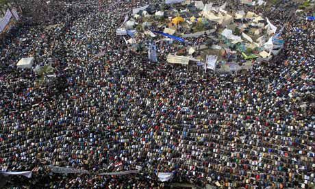 Demonstrators perform Friday prayers at Tahrir square in Cairo