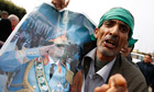 A supporter holds a picture of Libya's leader Muammar Gaddafi in Sabratha