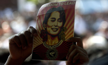 An Aung San Suu Kyi supporter holds up an image of her in Rangoon, Burma