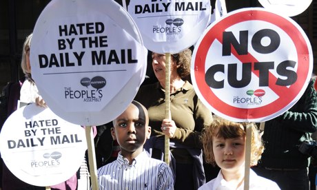 Children hold placards during the protest against the Daily Mail in London