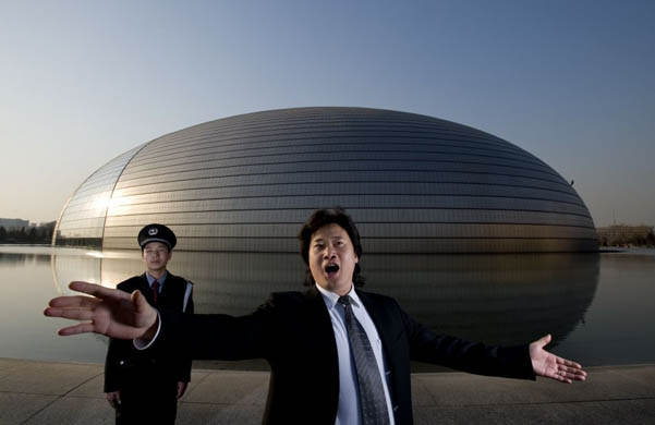 Opera singer Dai Yuqiang poses in front of the National Centre for Performing Arts