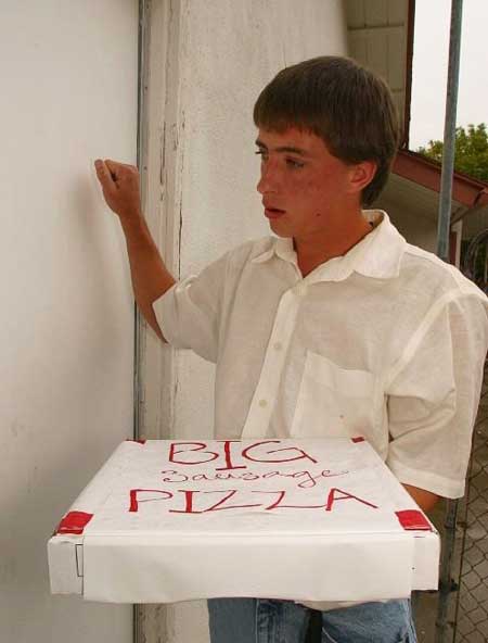 A pizza boy delivers food