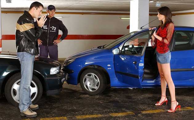 Two men and a women discuss the aftermath of a car collision