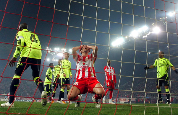 Olympiakos player covers his face