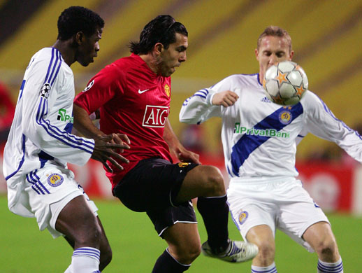 Carlos Tevez vies for the ball