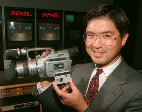 Sony Corp. Vice President Jay Sato holds the company's DCR-VX1000 digital handycam camcorder