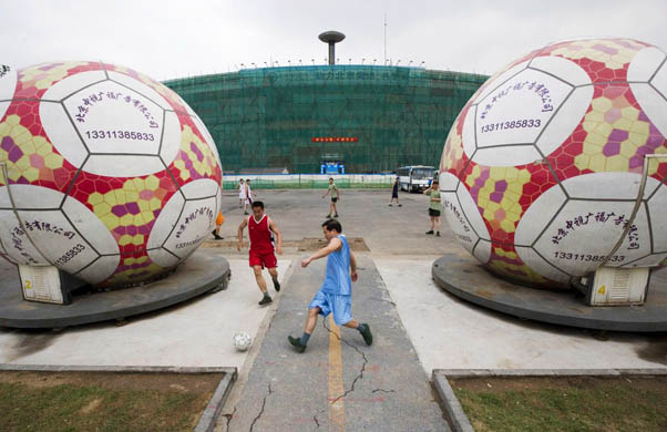 Players from the local police and military play soccer outside the Workers Stadium
