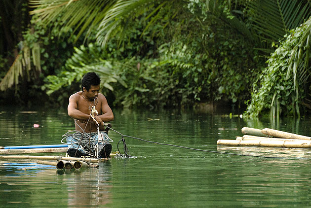 Man on a raft, Bohol, Philippines