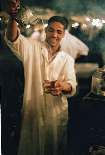 Boy pouring whiskey, Djeem al Fnaar, Morocco