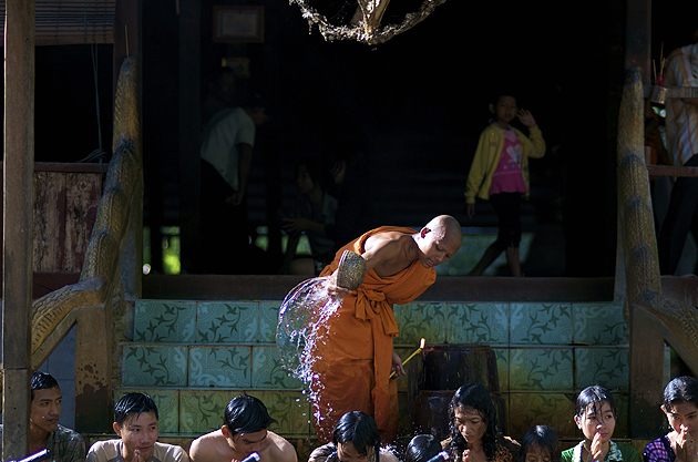 Buddhist monk blessing the faithful, near Angkor, Cambodia