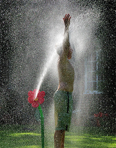 Boy being sprayed with water