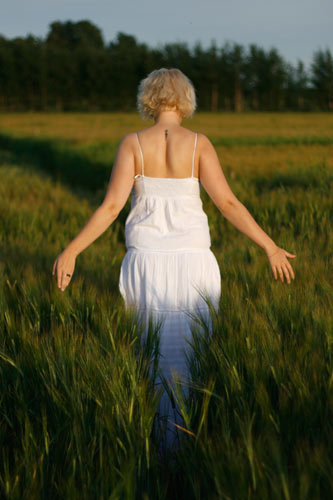 Girl walking through field