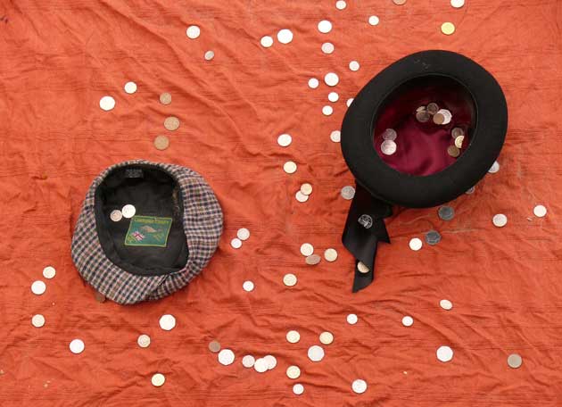 Taken on the South Bank in London. Coins being collected by a sand sculptor