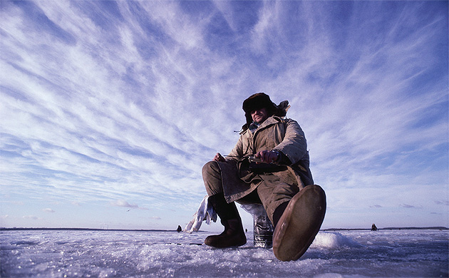 A man ice fishing in the frozen Volga River north of Moscow