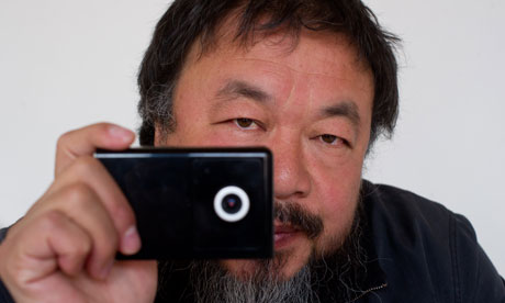 Artist Ai Weiwei holds a webcam he was reportedly ordered by Chinese police to disconnect