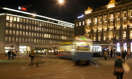 A tram drives past the offices of Swiss banks UBS and Credit Suisse at Paradeplatz square in Zurich