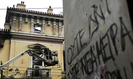 Firemen work on a damaged historic building in central Athens on February 13, 2012.