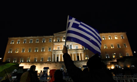 A protester holds up a Greek flag during a demonstration against anti-austerity measures in Athens