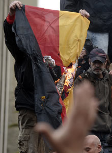 Protesters burn a German flag at parliament during a 24-hour strike in Athens on February 7, 2012. 