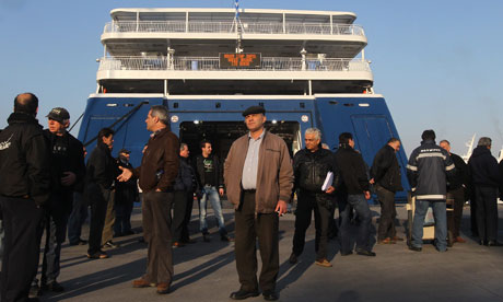 Striking seamen guard the hatch of a ship in the port of Piraeus, Greece..
