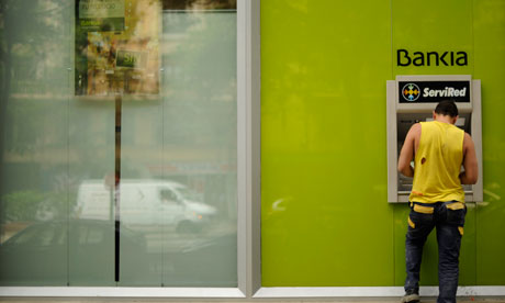 A man uses a Bankia ATM machine on May 17, 2012 in Madrid.