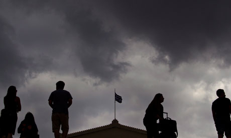 The Greek flag of the Parliament waves under heavy sky in Syntagma square, Athens, Greece