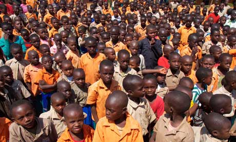 MDG : Rwanda : School children stand in their playground waiting for instructions