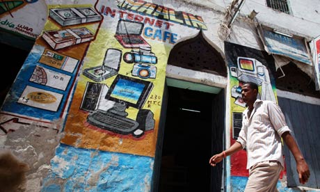 MDG : Somalia : A man walks past an Internet cafe in Hamarweyne district of capital Mogadishu