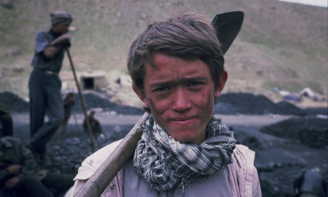 The Boy Mir: Ten Years in Afghanistan: Mir in 2009 holding pick in coal pit