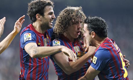 Barcelona's captain Carlos Puyol, centre, celebrates after scoring