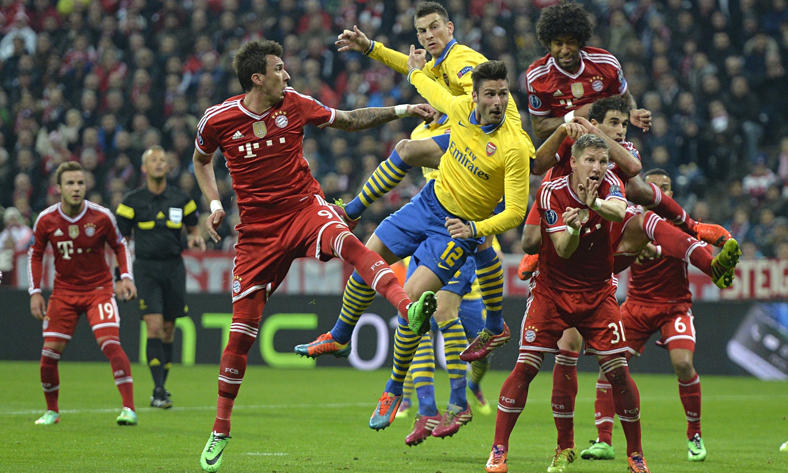  Arsenal and Bayern Munich players compete for a header during the second leg of their UEFA Champions League round-of-16 tie.