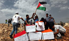 Palestinian and foreign activists prepare to burn boxes depicting Jewish settlements