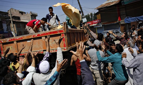 Volunteers in Srinagar hand out supplies