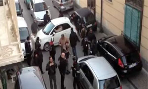 Car horizntal on Naples street surrounded by people