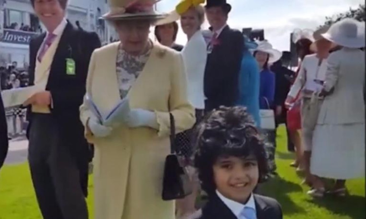 Queen charmed by boy who takes off top hat to shake hands at Epsom – video