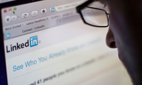 Man in glasses looking at the Linkedin website 