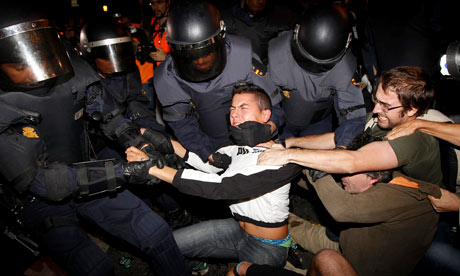 Riot police struggle with protesters during demonstrations in Madrid 