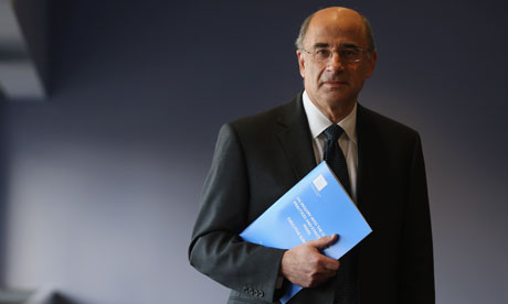 Lord Justice Leveson poses with a summary report into press standards
