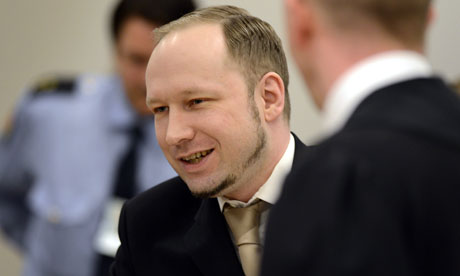 Anders Behring Breivik smiles as he greets prosecutors at the start of his trial 