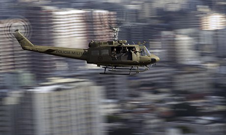 A Brazilian military police helicopter flies over the Lins favela in Rio de Janeiro, during peace op