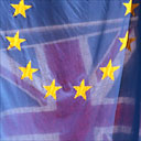 A European Union flag flies next to a Union Jack flag