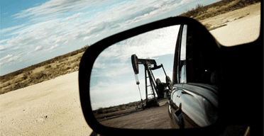 A Texan oil field seen in the wing-mirror of a car