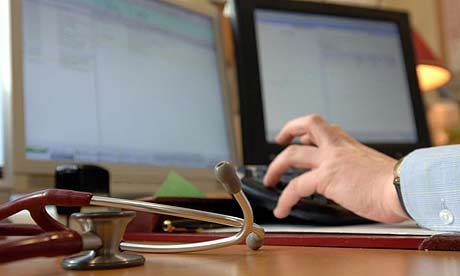 A GP in his surgery. There are fears private information could be given to researchers