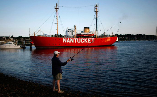Jonathan Kramer fishes from the shores of Vineyard Haven, Massachusetts on the island of Martha's Vineyard